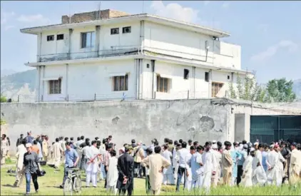  ??  ?? Outside the hideout of AlQaeda leader Osama bin Laden a couple of days after he was killed by US Special Forces in a ground operation in Abbottabad on May 1, 2011. As the authors of The Exile write in the accompanyi­ng piece, the villa was the scene of...