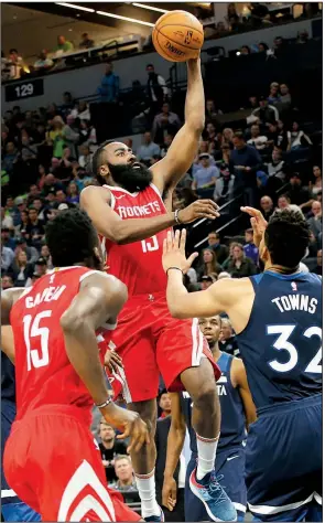  ?? AP/JIM MONE ?? Houston Rockets guard James Harden (center) attempts a shot as Minnesota’s Karl-Anthony Towns (right) defends during the second half of Game 4 of the NBA Western Conference first round Monday night at the Target Center in Minneapoli­s.