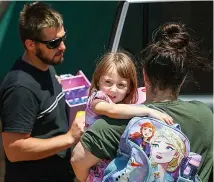  ?? Pictures: TAMATI SMITH/GETTY ?? Relief... Cleo with mum Ellie and Jake after she was found 18 days after going missing from a campsite. Right, shackled suspect Terence Kelly with police