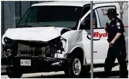  ??  ?? Wrecked: An officer inspects the damaged white rental van