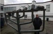  ?? JIM MAHONEY PHOTOS / HERALD STAFF ?? LIGHTS OUT: Brookline’s Temple Emeth Rabbi Alan Turetz stands next to the 6-foot-tall menorah that was torn from its base and found in West Roxbury.