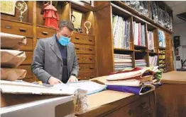  ?? ANDREW MEDICHINI AP ?? A shop attendant prepares orders in the Gammarelli clerical clothing shop in Rome on Thursday. Pope Francis today will elevate 13 clerics to cardinals.