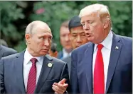  ?? AP PHOTO BY JORGE SILVA ?? U.S. President Donald Trump and Russia’s President Vladimir Putin talk during the family photo session at the APEC Summit in Danang, Vietnam, Saturday.