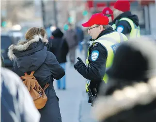  ?? MARIE-FRANCE COALLIER ?? Sgt. Yves Landry explains the rules to a citizen at the corner of Côte-des-Neiges Rd. and Jean-Brillant St. during a safety blitz by police on Tuesday in response to a string of pedestrian deaths.