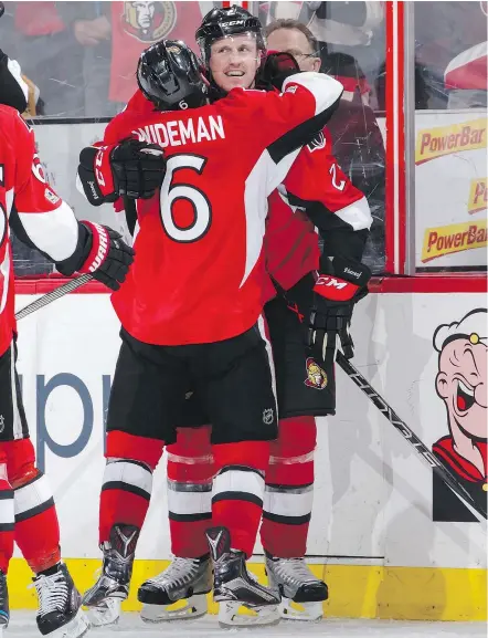  ?? — GETTY IMAGES ?? Dion Phaneuf gets a hug from teammate Chris Wideman after scoring in overtime to give the Senators a 4-3 win over the visiting Bruins in Game 2 of their first-round playoff series.