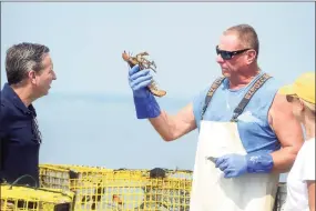  ?? Ned Gerard / Hearst Connecticu­t Media ?? Lobsterman Mike Kalaman speaks with state Sen. Bob Duff onboard the Dark Horse while he pulls up his lobster traps on Long Island Sound off the coast of Norwalk on Tuesday.