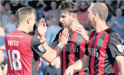  ?? David Tolliday ?? Kieran Kennedy, centre, is congratula­ted after scoring the second goal at Chester on Monday