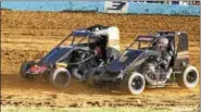  ?? SUBMITTED PHOTO - CARL HESS ?? Wheel-to-wheel clay-slinging action between Kyle Spence (#X7) and Jason Swavely (#99) in the 600Micro Sprint division at Action Track USA.