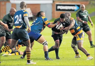  ?? Picture: ALAN EASON ?? BARGING THROUGH: Yanga Xanda from Winter Rose is held up by the Police defence during the Flya Cup Tournament held at the Old Selbornian Club field on Saturday