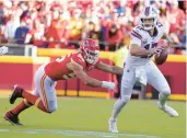  ?? ED ZURGA/AP ?? QB Josh Allen scrambles away from Chiefs DE George Karlaftis during the Bills’ 24-20 road victory Sunday.