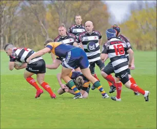  ??  ?? Kilchoan’s Ross Rankin is tackled by a Shawlands defender.