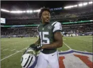  ?? ASSOCIATED PRESS FILE ?? Jets wide receiver Brandon Marshall walks off field after game against Patriots. A person with direct knowledge of the team’s decision says the Jets are releasing Marshall, clearing $7.5 million on the salary cap. Marshall is the latest big-name player...