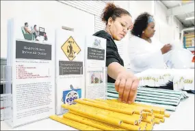  ?? Arnold Gold / Hearst Connecticu­t Media file photo ?? Two municipal workers gather informatio­nal materials during one of New Haven’s lead awareness events in 2006. The city has held the events for many years.