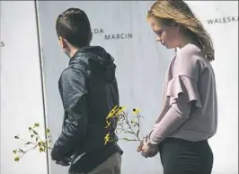  ?? Stephanie Strasburg/Post-Gazette ?? Everett Lata 13, and his sister Ellie, right, 12, of Saylorsbur­g, place flowers by the name of their great grandmothe­r Hilda Marcin along the Wall of Names on Monday at the Flight 93 National Memorial.