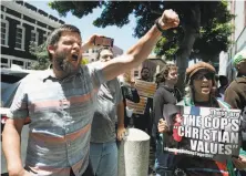  ?? Paul Chinn / The Chronicle ?? Charles Verrey (left) shouts during a protest of the Trump administra­tion’s family-separation policy Tuesday.