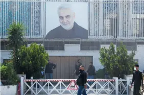  ?? (Firas Makdesi/Reuters) ?? A PICTURE of previously assassinat­ed senior Iranian military commander Gen. Qasem Soleimani is placed on the Iranian Embassy building in Damascus after a suspected Israeli strike on Iran’s adjacent consulate killed key Quds Force figures, this week.
