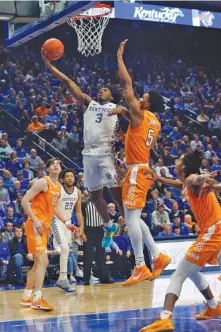  ?? AP PHOTO BY JAMES CRISP ?? Kentucky’s Tyrese Maxey drives to the basket as Tennessee freshman guard Josiah-Jordan James defends during the second half of Tuesday night’s game in Lexington, Ky. James had 16 points, seven rebounds, five assists, two steals and a block to help the Vols beat the No. 6 Wildcats 81-73. Tennessee hosts Auburn on Saturday to close the regular season.