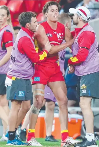  ?? Picture: GETTY IMAGES ?? David Swallow is helped from the field by trainers after being flattened.