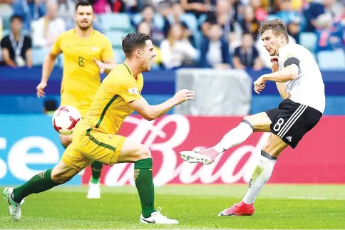  ?? — AFP photo ?? Germany’s midfielder Leon Goretzka shoots the ball past Australia’s defender Milos Degenek during the 2017 Confederat­ions Cup group B football match between Australia and Germany at the Fisht Stadium in Sochi on June 19, 2017.