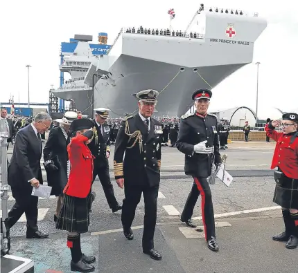  ??  ?? Above: the Duke and Duchess of Rothesay arrive for the naming ceremony of aircraft carrier HMS Prince of Wales at Rosyth dockyard. Below: the ship’s company prepare for a photocall after the ceremony.