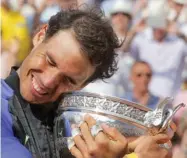  ?? (Photo by Michel Euler, AP) ?? Rafael Nadal hugs the cup after defeating Stan Wawrinka in the final of the French Open on Sunday.