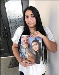  ?? ?? Jenifer Flores holds a picture of her husband, Ramiro Andrade, and herself. Andrade was last seen Oct. 8 in Mexico.