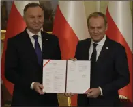  ?? (AP/Czarek Sokolowski) ?? Poland’s new Prime Minister Donald Tusk (right) and Poland’s President Andrzej Duda pose for cameras during the swearing-in ceremony on Wednesday at the presidenti­al palace in Warsaw, Poland.