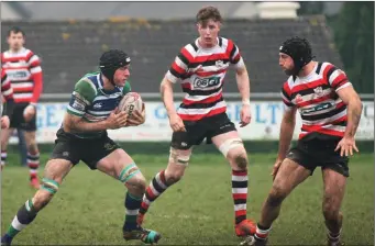  ??  ?? J.P. Redmond of Gorey taking on Enniscorth­y duo Nick Doyle and Greg Jacob.