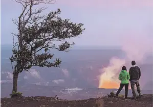  ??  ?? PHOTOS COURTESY OF HAWAII TOURISM AUTHORITY LAVA LOVE: A couple watches the glow of Halemaumau Crater on the Big Island.