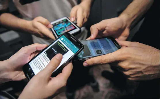  ?? AFP/GETTY IMAGES ?? Look around a coffee shop these days and you’ll likely see most people engrossed in their little digital screens, Jennifer Allford writes.