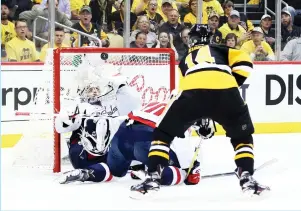  ?? (Reuters) ?? WASHINGTON CAPITALS goalie Braden Holtby makes a glove save on a shot by Pittsburgh Penguins forward Chris Kunitz in the second period of the Capitals’ 3-2 overtime road victory on Monday night in Game 3 of the teams’ Eastern Conference second-round...