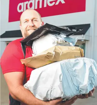  ?? Picture: ALIX SWEENEY ?? LOADS OF WORK: Aramex Townsville owner Darren Woolage has seen an increase in business during the pandemic.