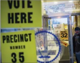  ?? JAKE MAY/THE FLINT JOURNAL - MLIVE.COM VIA AP ?? In this Tuesday, Nov. 8, 2016 file photo, a man walks out of City Hall after voting in downtown Flint, Mich. An Associated Press analysis, using a new statistica­l method of calculatin­g partisan advantage, finds traditiona­l battlegrou­nds such as...