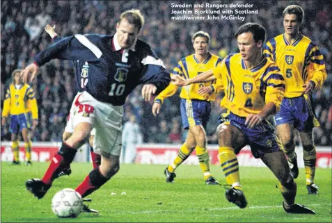  ??  ?? Sweden and Rangers defender Joachim Bjorklund with Scotland matchwinne­r John McGinlay