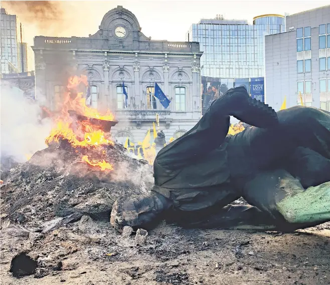  ?? ?? The toppled statue of John Cockerill, a British steel baron, lies on its side in the Place du Luxembourg, right, during protests by Belgian farmers in Brussels, below; Emmanuel Macron addresses a press conference at the meeting of the European Council, below right
