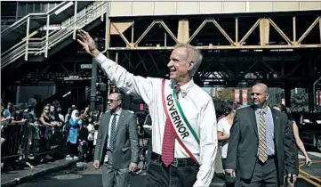  ?? E. JASON WAMBSGANS/CHICAGO TRIBUNE ?? Bruce Rauner wears the governor’s sash as he walks in the Columbus Day Parade in Chicago last week.