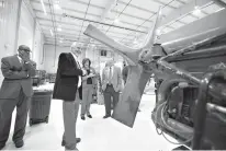  ?? Staff photo by Evan Lewis ?? n Bill Archer, dean of Instructio­nal Academics, talks about one of the motors used in the Aviation Maintenanc­e program at Southern Arkansas University Tech. Chancellor Jason Morrison and city leaders from both side of the state line toured the...