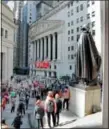  ?? RICHARD DREW — THE ASSOCIATED PRESS FILE ?? A statue of George Washington on the steps of Federal Hall overlooks the New York Stock Exchange.