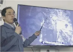  ??  ?? 0 A Tepco worker explains operations at Fukushima nuclear plant