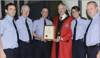  ??  ?? Garda David Rothwell accepts an award on behalf of Supt Andrew Watters, with Pat Sheridan, John O’Flaherty, Sinead Malone and Donal Mc Givern