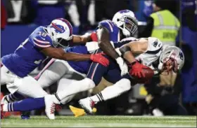  ?? ADRIAN KRAUS - THE ASSOCIATED PRESS ?? New England Patriots’ Julian Edelman, right, collects a punted ball as Buffalo Bills’ Andre Holmes, left, and Ramon Humber tackle him down during the second half of an NFL football game, Monday, Oct. 29, 2018, in Orchard Park, N.Y.