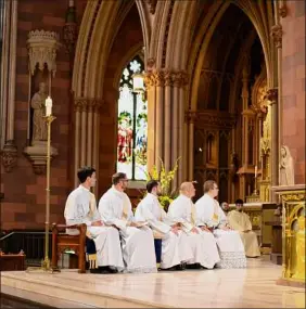  ??  ?? Deacons listen to Bishop Edward Scharfenbe­rger during their ordination June 19 into the Albany Roman Catholic Diocese.