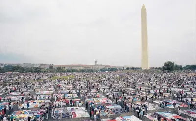  ?? STEPHEN R. BROWN/AP 1992 ?? Thousands of people examine individual panels of the AIDS quilt on the National Mall in Washington.