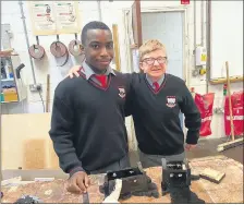  ?? ?? Students of Coláiste Fionnchua who played a part in manufactur­ing the wooden boxes for dog waste bags, for installati­on around town.