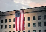  ??  ?? A large American flag is unfurled at the Pentagon