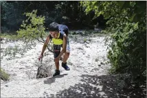  ?? AMANDA VOISARD / AMERICAN-STATESMAN ?? Luis Luna, 9, hikes an Austin greenbelt trail Monday seeking water to cool off in. He and his family began at Twin Falls, but it was dry, so they kept hiking toward Sculpture Falls.
