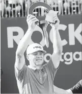  ?? CARLOS OSORIO THE ASSOCIATED PRESS ?? Nate Lashley raises the winner’s trophy after the final round of the Rocket Mortgage Classic golf tournament Sunday in Detroit.