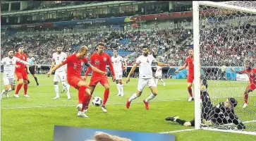  ??  ?? KANE GAME Harry Kane fires England into an early lead, left, but Kyle Walker’s clumsy elbow gifts Tunisia a lifeline, below, before boss Gareth Southgate roars with delight after Kane pops up to head home the winner, main
