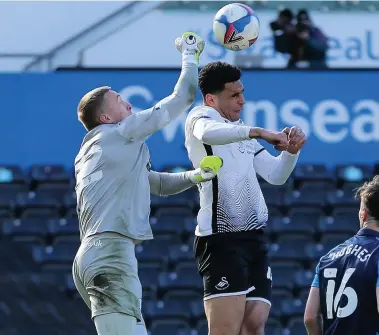  ?? Gareth Everett/huw Evans Agency ?? Preston goalkeeper Daniel Iversen punches clear from Ben Cabango.