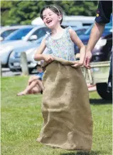  ?? PHOTO: RICHARD DAVIDSON ?? Jumping into the new year . . . Katie Milne (5), of Invercargi­ll, has fun in the sack race at the Papatowai Beach Carnival.